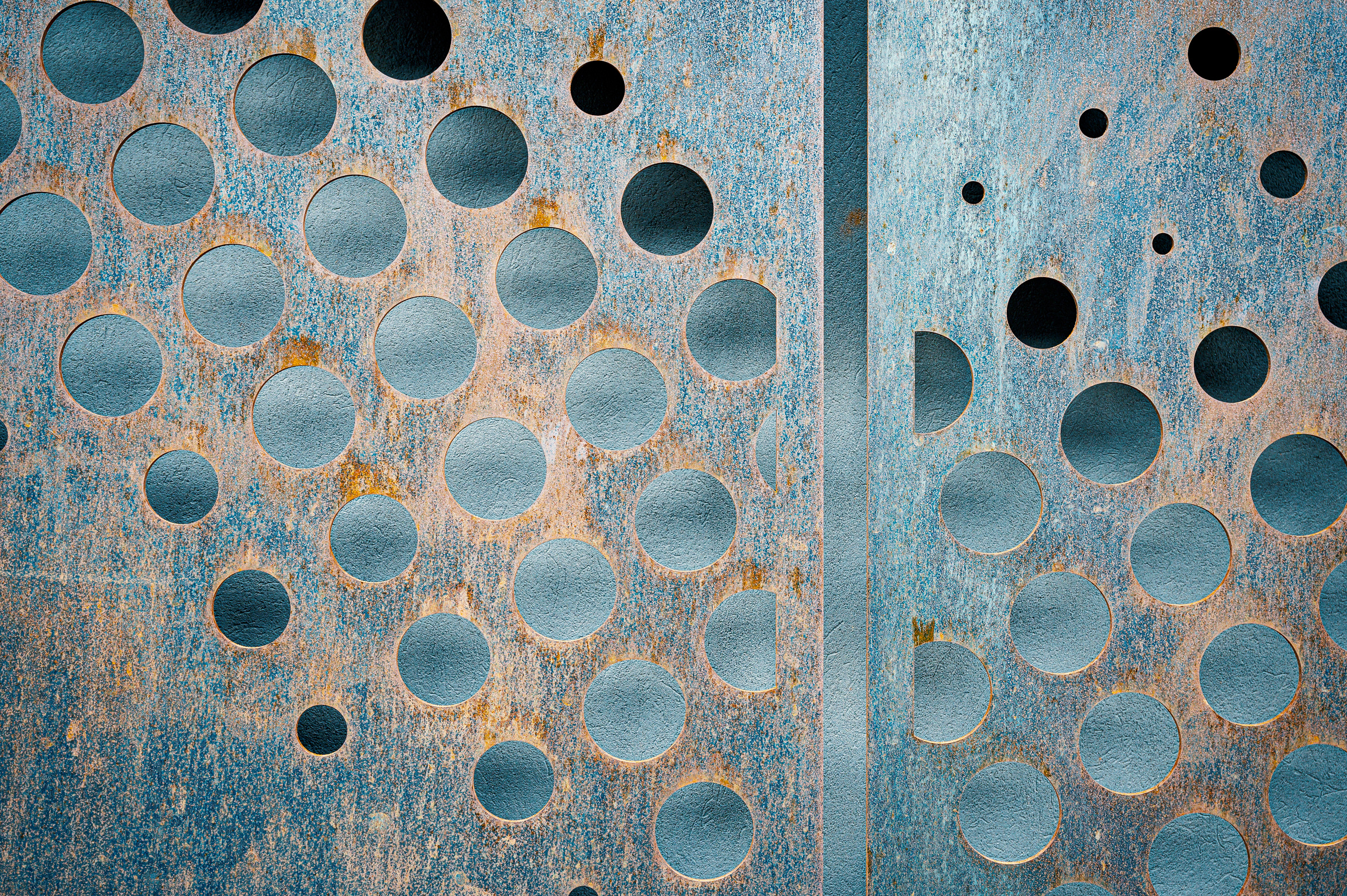 Rusted metal panels with carved circles